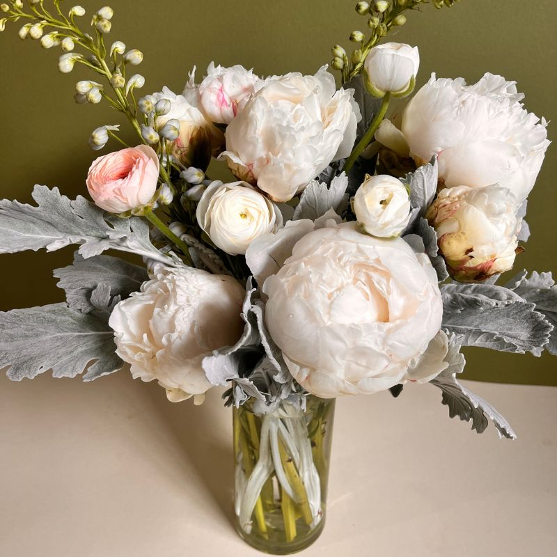Funeral arrangement of white peonies and white ranunculus